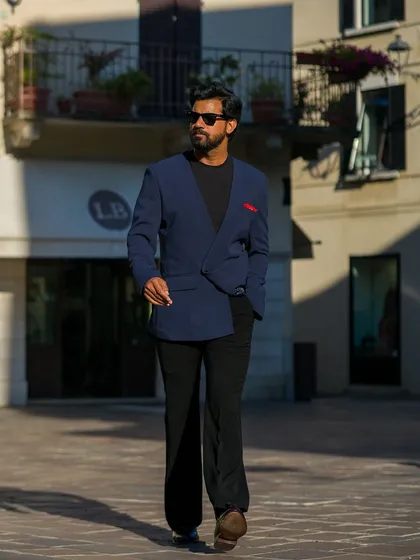 The lapel-free blazer, styled with a red pocket square for a pop of color.