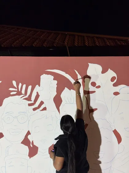 A shot of me in action, carefully filling in the outlines of the mural.