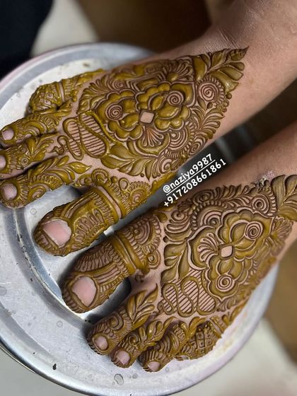 A close-up of the feet of the engagement bride. The design is just as detailed and beautiful as the henna on her hands.