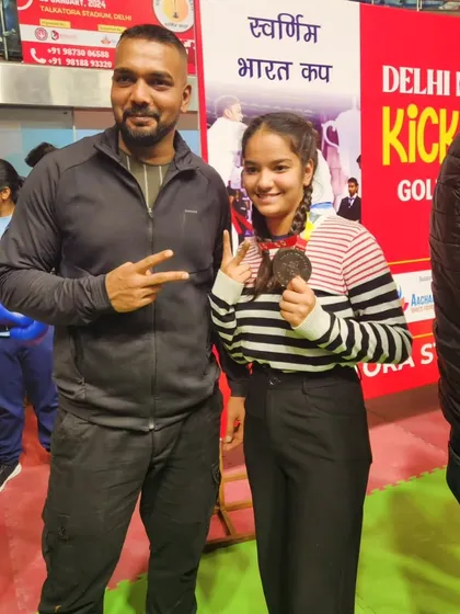 A proud moment with one of our young female champions after her kickboxing match.
