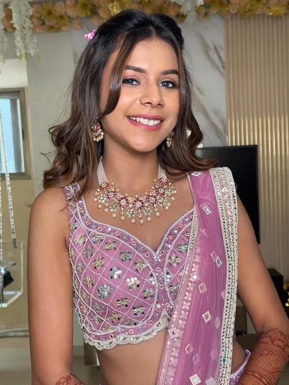 A lovely front view of a bridesmaid's hairstyle. I created a soft, wavy look with a twisted half-up detail and face-framing pieces for a youthful and fresh appearance.
