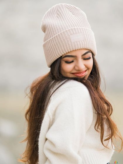 A close-up portrait with a beanie, capturing a serene and gentle expression.