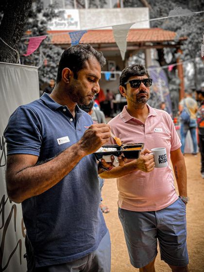 Even our supporters enjoy the event. Here, a friend of the community enjoys a snack while wearing a 'Just Ride' mug.
