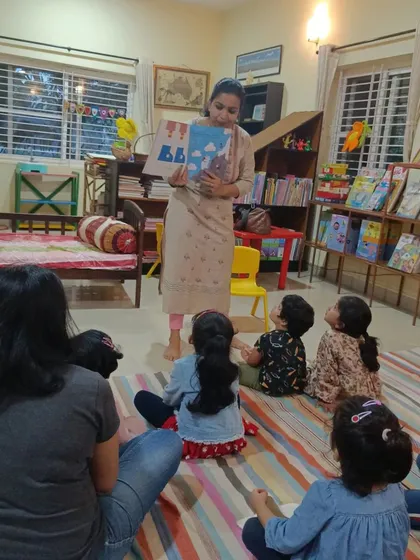 A focused shot on the children's upturned faces as they listen to the story.