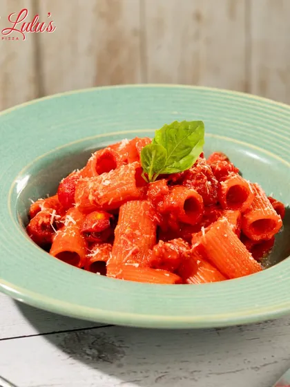 A close-up of my Rigatoni Arrabbiata. The vibrant red sauce and fresh basil leaf make this dish a feast for the eyes and the palate.