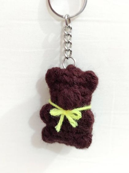 Cute and chewy-looking gummy bear keychains with little bows, available in white, brown, and lavender.