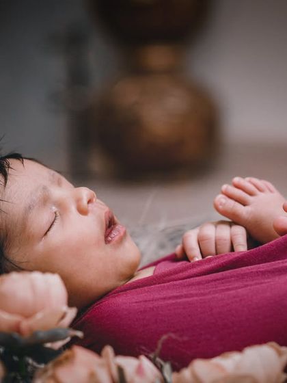 The sweetest dreams. This side-angle shot of a swaddled baby shows off their tiny profile and delicate features.