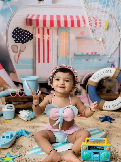 Clapping her hands with joy! This little girl loved her beach-themed photoshoot.