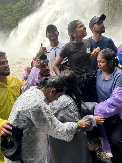 Our group of adventurers getting drenched in the spray of Dudhsagar Falls. Wearing ponchos is a must, but feeling the mist is part of the fun.