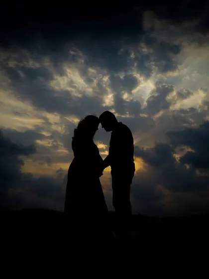 Sometimes the most powerful moments are the quiet ones. I love taking couples outdoors for a natural light session, creating romantic silhouettes like this against the evening sky.