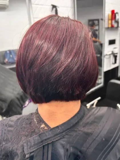 A sleek, sharp bob with a deep red wine color. This look proves that short hair can make a huge statement, especially with a rich, uniform global color.