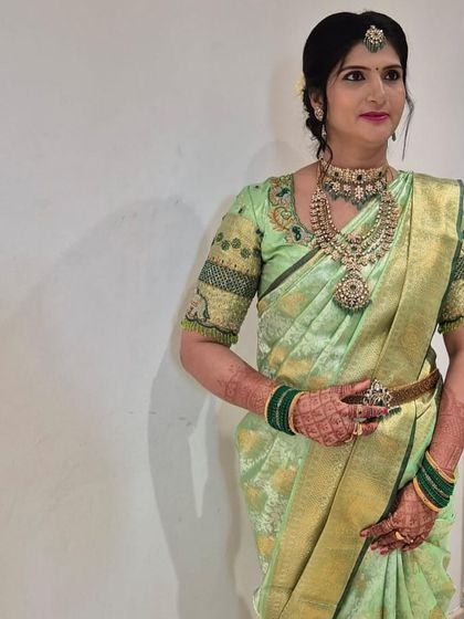 Vedha's poise and the intricate embroidery on her blouse showcase her impeccable style.