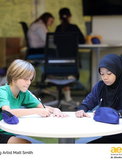 Two students collaborate on a drawing exercise during a workshop. We foster a collaborative learning environment where students can learn from both the visiting artist and each other.