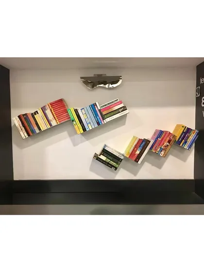A full installation of the floating bookshelves within a custom wall niche.