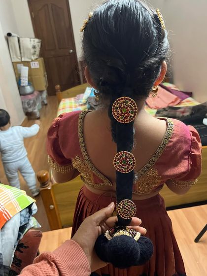 A traditional braid for a little girl, adorned with beautiful temple jewellery hair accessories. It's so fun to style the little ones.