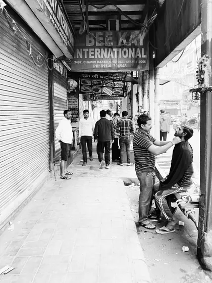 A candid moment of daily life: a man gets a shave on a busy sidewalk in Chawri Bazar. Our tours are as much about observing the local culture as they are about seeing monuments.