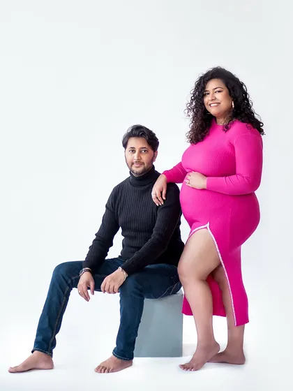 A stylish and confident pose that shows the beautiful bond between partners in a modern studio setting.