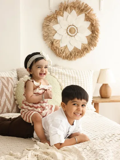 The first friendship. Capturing the bond between siblings is one of my greatest joys. In this cozy, boho-inspired setup, we see the pure delight and connection between a big brother and his baby sister, a memory this family will treasure forever.