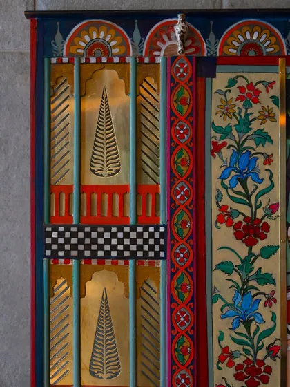The transformation of the jharokha-like opening. I commissioned a local engraver to create this hand-engraved brass insert with a poplar tree motif, replacing the damaged mesh with a touch of polished elegance.
