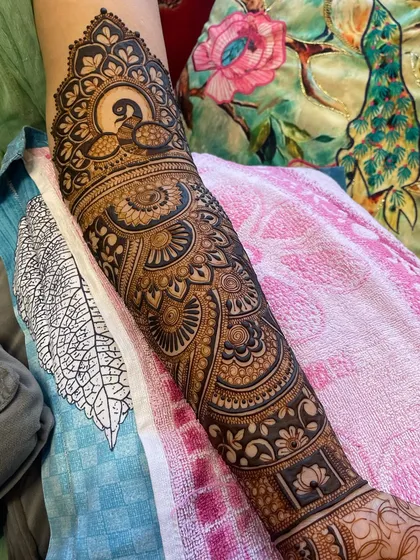 Another angle of the peacock-themed arm design, showing the beautiful shading and detail.