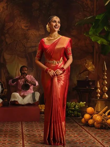 A full-length view of the stunning red silk saree from the Pothys shoot. The drape is designed to create a powerful and graceful silhouette.