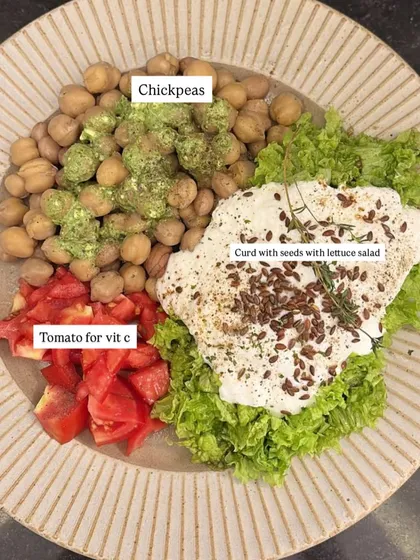 A balanced plate is the foundation of hormonal health. This is an example of a client's meal, featuring protein from chickpeas, healthy fats from seeds, and essential vitamins from fresh vegetables. My plans are designed to be nourishing, not restrictive.