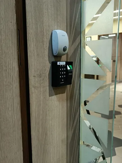 A duplicate image of the TD1D reader installation in Mayapuri, showing its placement next to a patterned glass door.