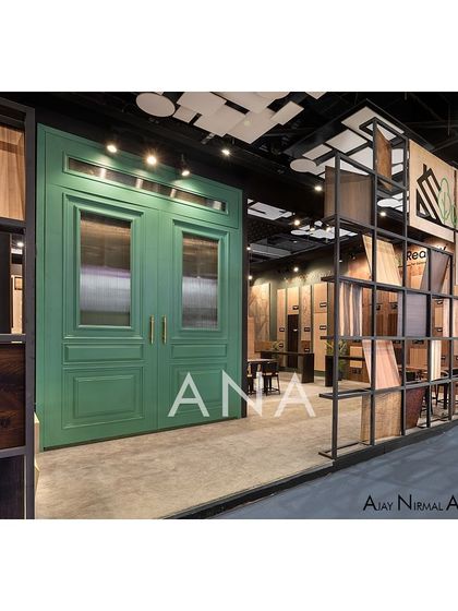 This shot highlights the contrast between the raw, industrial grid displaying veneer sheets and the refined, classic green door. This juxtaposition was a key part of the design concept for the Realply '23 experience zone.