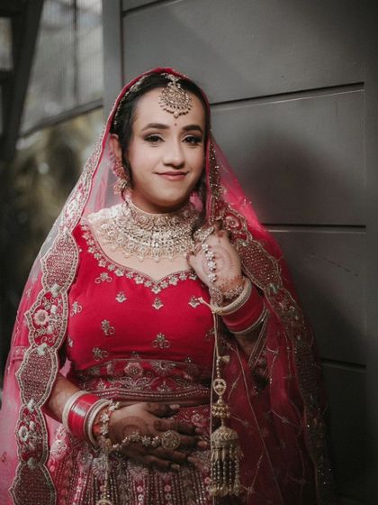 A beautiful three-quarter portrait of Shreya, her gentle smile and stunning jewelry making for a perfect bridal shot.