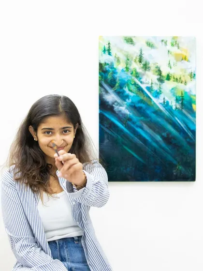 Posing with my "Pahaadi" (mountain) painting. This piece captures the feeling of being in the mountains, with misty forests and ethereal light. It's available for purchase or similar commissions.