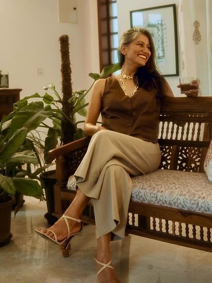 The full look, showing how the waistcoat and flared trousers create a flattering, elongated silhouette.