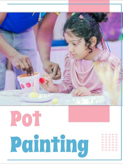 A young girl carefully painting a terracotta pot. This pot painting activity is both creative and can be tied into an eco-friendly theme.