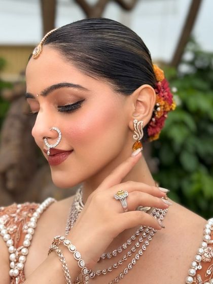 Another angle of the elegant floral bun and the flawless profile. The makeup is set to last all day, from the morning ceremony to the evening celebrations.