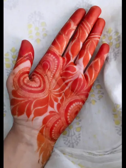 The beautiful orange-red stain of a Khaliji-style henna design. This style uses bold patterns and negative space, which results in a very striking stain.