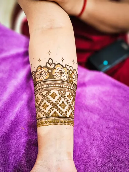 A close-up of the armband, featuring a band of delicate roses.