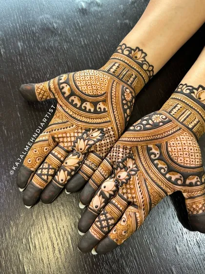 A lovely design for the groom's sister, featuring small elephants marching around a central pattern.