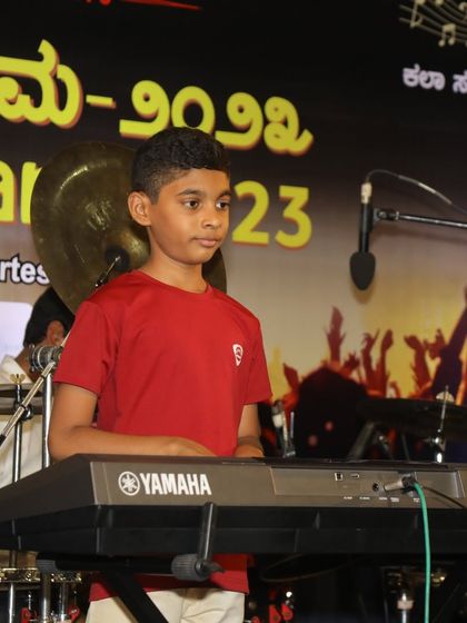 A young boy at his Yamaha keyboard, part of the Independence Day performance.