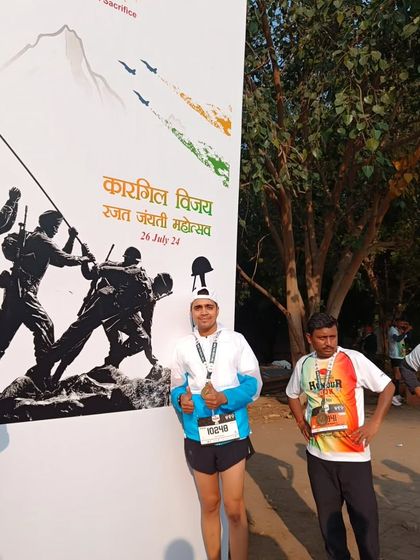 Posing in front of a poster for the Kargil Vijay Rajat Jayanti Mahotsav after the Honour Run. A run dedicated to our heroes.