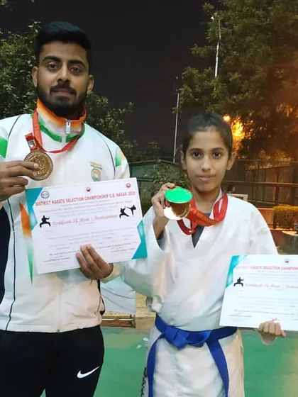 Another one of my champions, a young female student, with her gold medal and certificate from the district karate selection championship. At our academy, everyone has the potential to be a winner.