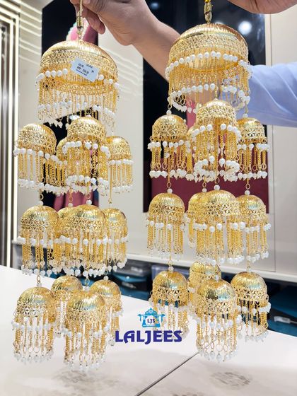 Another stunning kaleera design with intricate metalwork and delicate pearl chains.