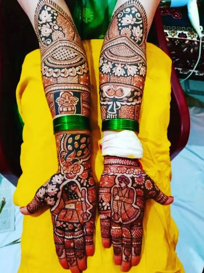 A colorful and vibrant portrait mehendi. The design shows the couple on the palms, with green bangles complementing the henna color.