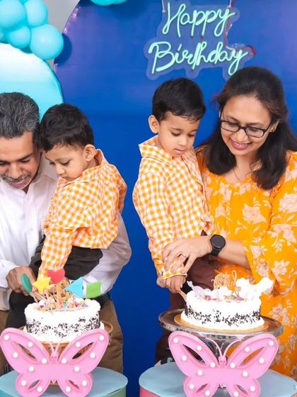 A special moment for twin boys celebrating their third birthday. The whole family joins in for the double cake cutting, a memory they will surely treasure.