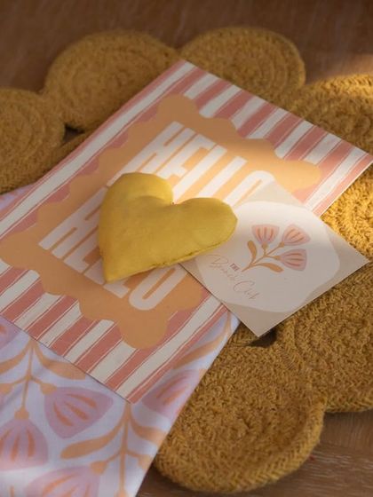 A close-up of the thoughtful details, including a custom menu, a heart-shaped cushion, and a flower-shaped placemat.