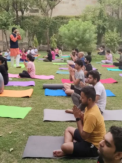 Leading a large group in an outdoor yoga session on International Yoga Day. There is a unique energy when a community comes together to practice in a natural, open-air setting.