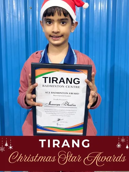 A young player proudly holds his "Ace Badminton Award" during our Christmas celebrations. Recognizing effort and sincerity helps build a strong foundation for lifelong success.
