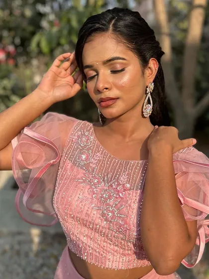A beautiful outdoor portrait. The makeup looks fresh and radiant in the natural sunlight.