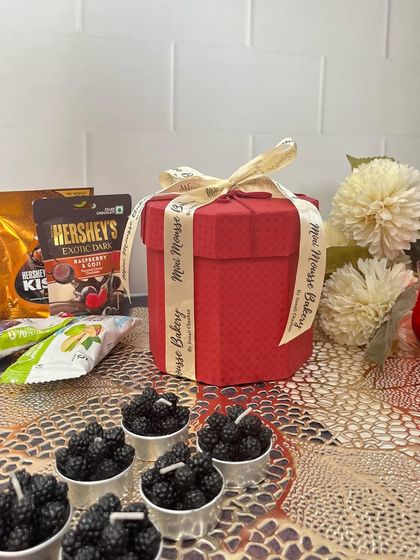 Another look at my festive red box hamper, perfect for Diwali. It includes a mix of treats and pretty blackberry-shaped candles, making it a complete and thoughtful gift.