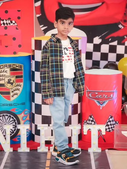 A thrilling 'Hot Wheels' themed birthday party, with checkered flags, car cutouts, and a custom racetrack backdrop, perfect for little speed enthusiasts.