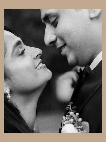 A classic black and white portrait that feels timeless. The soft smiles and close embrace between the couple create a feeling of warmth and genuine affection.