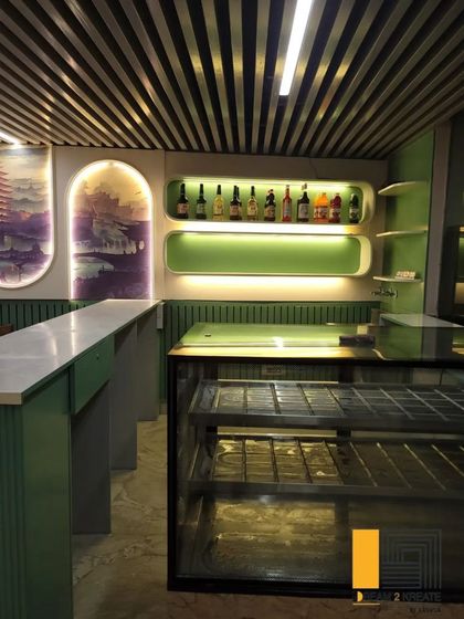 The bar and service area at Rigo Restaurant is designed with clean lines and integrated shelving, ensuring an efficient and organized workspace.